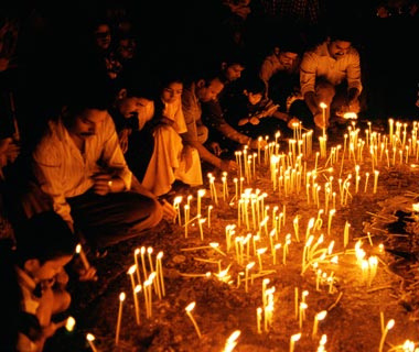 Local Christians lighting candles during Christmas deliberations in Panjai Goa India. Image shot 2004. Exact date unknown.