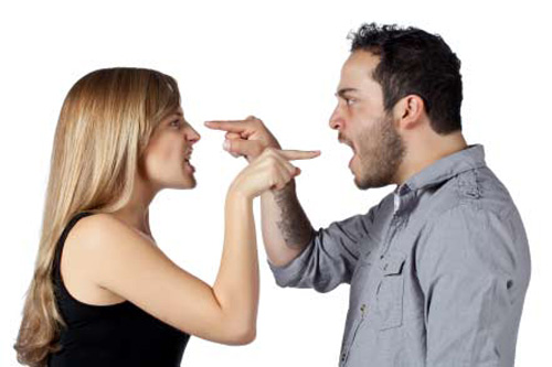 Horizontal image of a couple pointing a finger on each other